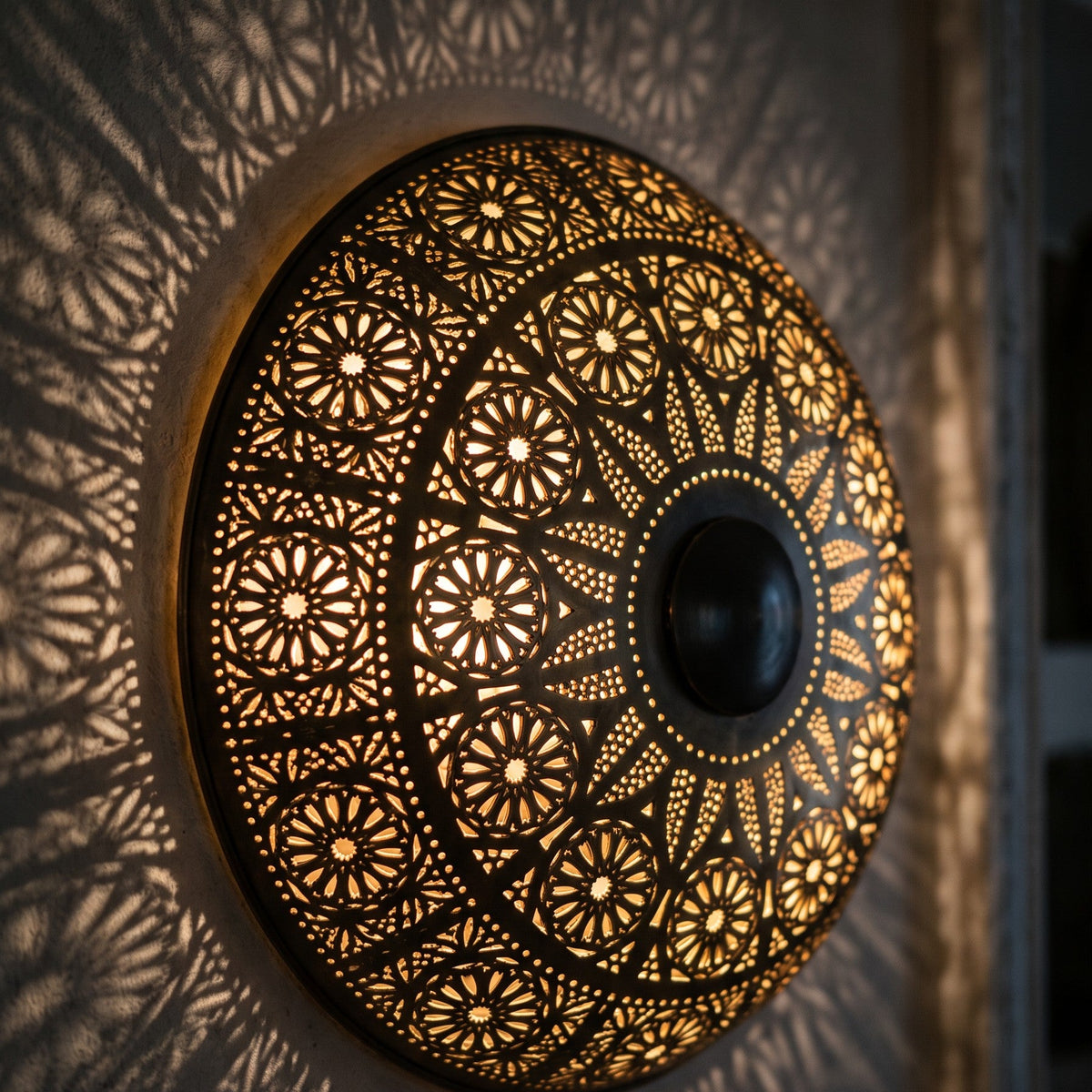 Close detail of the lit Tafraout, punched circles and floral cutwork glowing