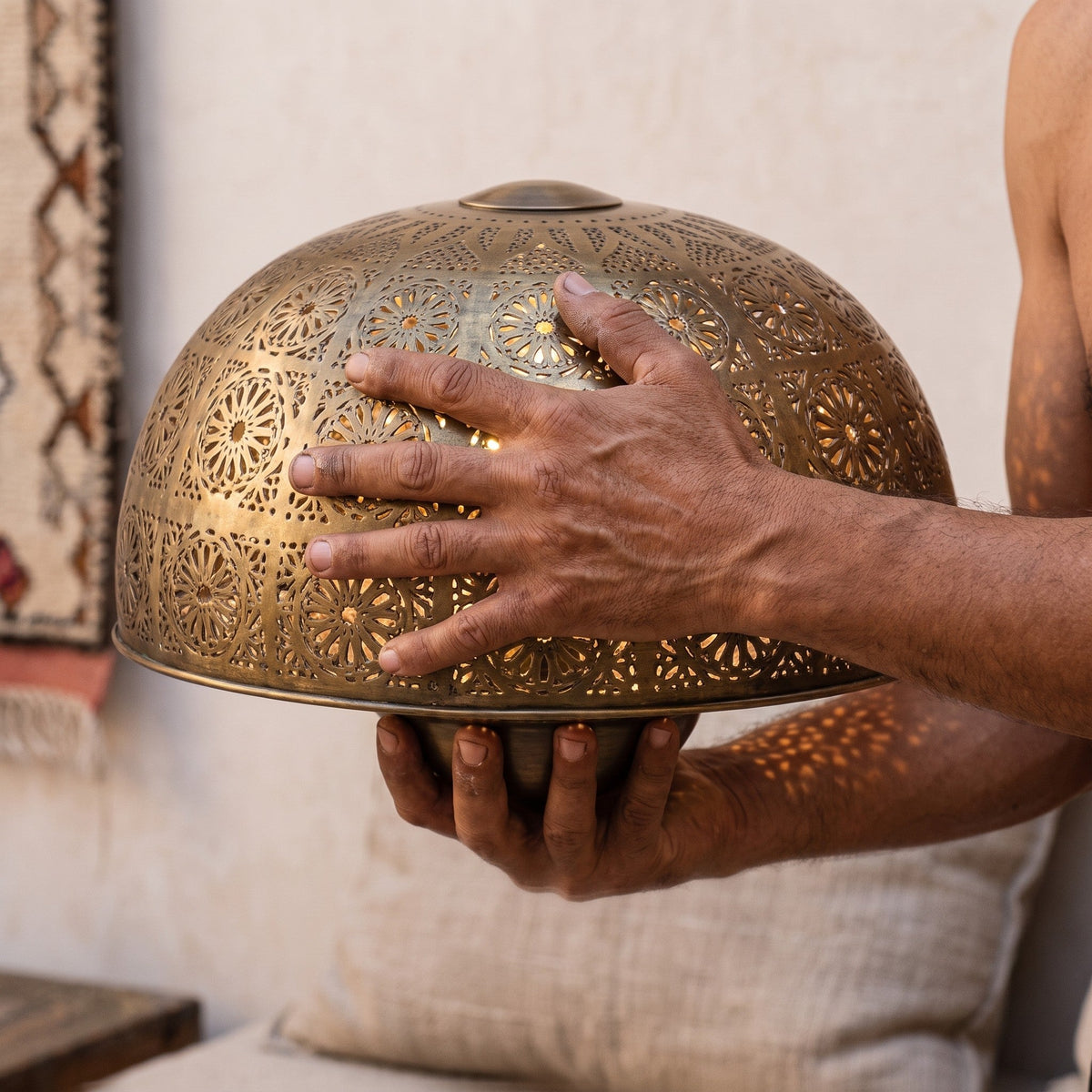 The Tafraout disc held in the maker's hands, punch work visible
