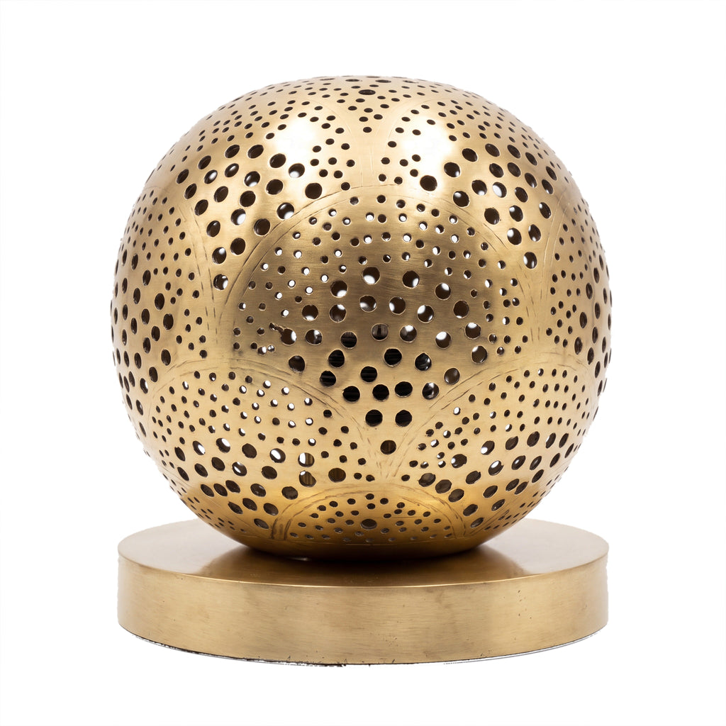 Tala pierced brass sphere table lamp on a white studio background