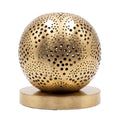 Tala pierced brass sphere table lamp on a white studio background