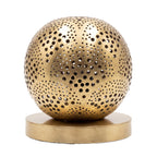 Tala pierced brass sphere table lamp on a white studio background