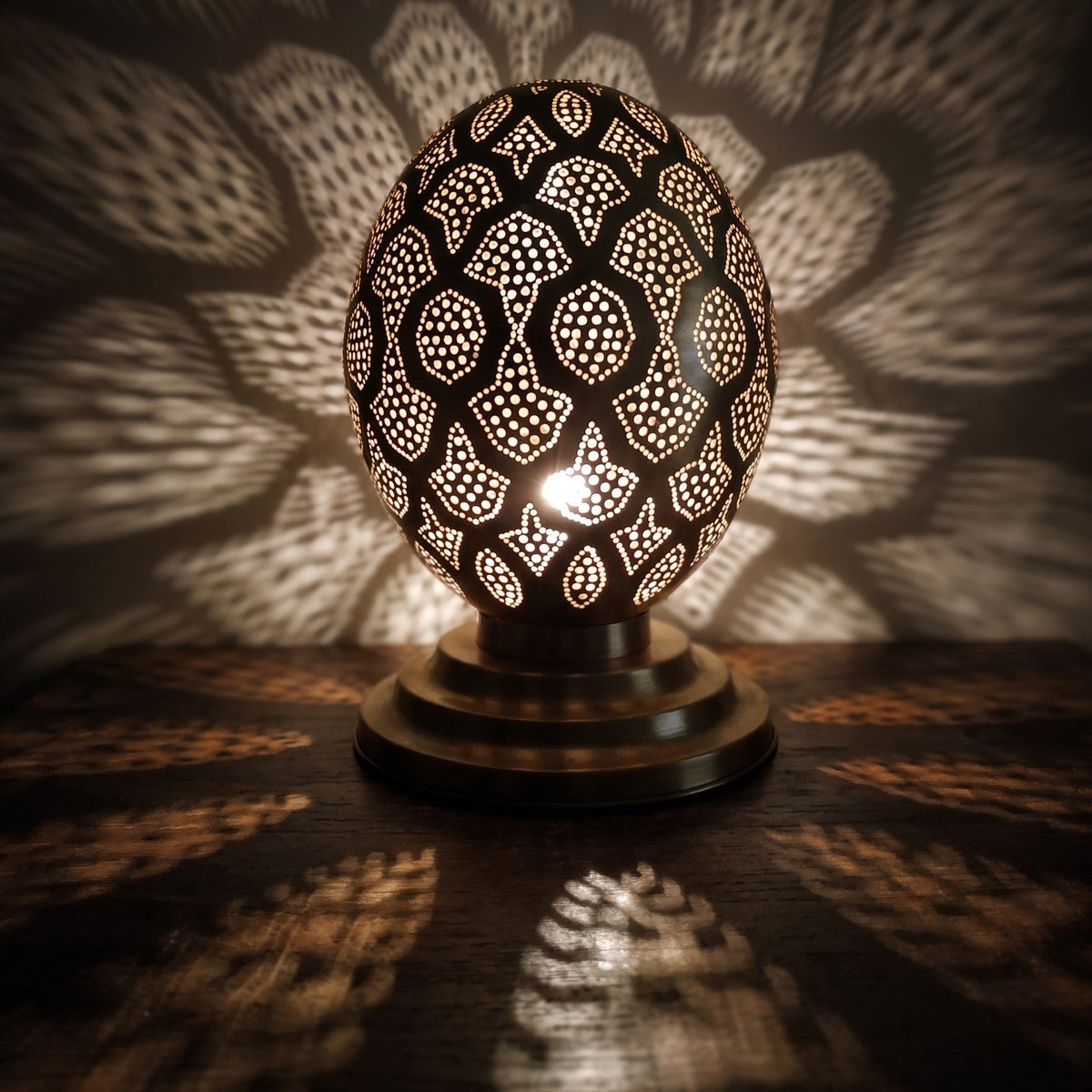 Close view of the lit Tamment lantern, points of light through perforated brass