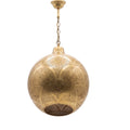 Tanirt pierced brass pendant on a white studio background