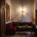 Tarz sconce casting its pattern on a tadelakt wall in a Moroccan riad