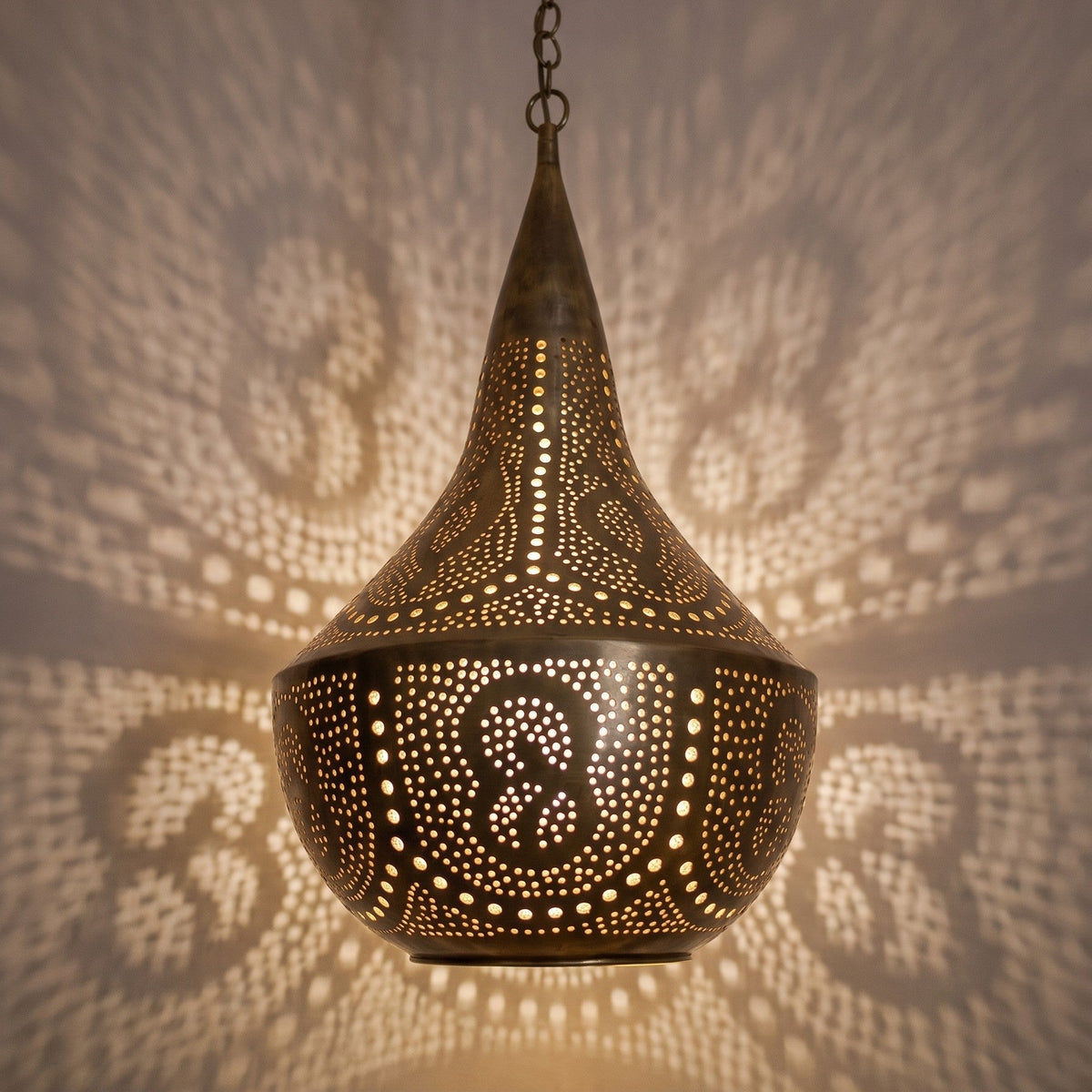 Detail of the lit Telouet pendant, wide piercings glowing brightly