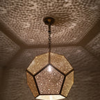 Close view of the lit Thouraya pendant, points of light on each facet