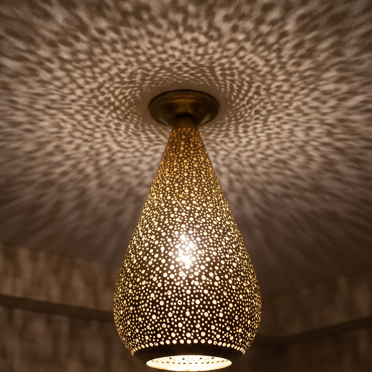 Detail of the lit Tichka dome, light passing through rows of hand-punched openings
