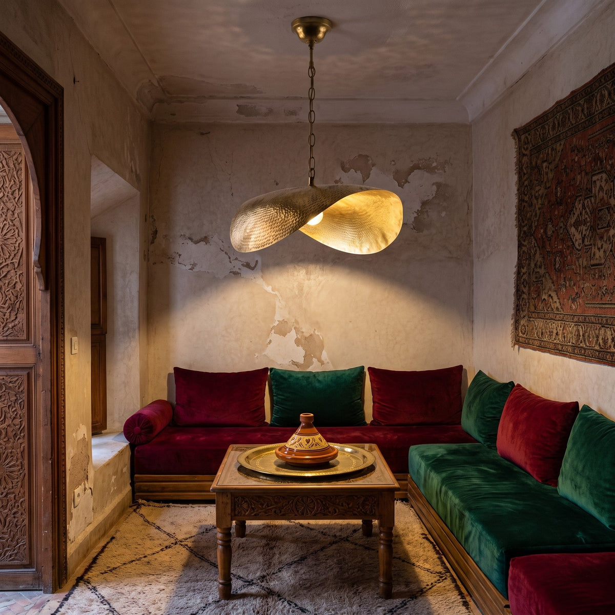 Warqa hammered brass pendant hanging in a Moroccan riad interior