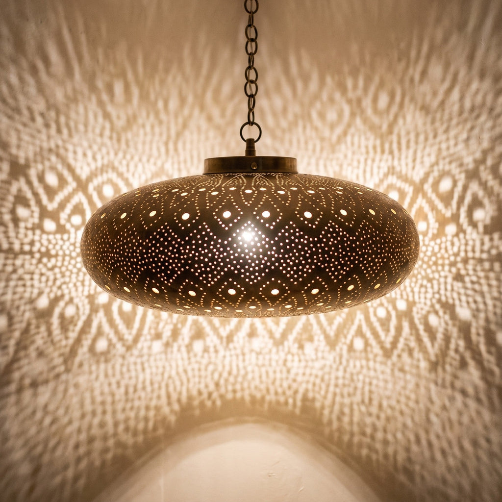 Close view of the lit Yakout pendant, light coming through the pierced leaf pattern