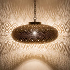 Close view of the lit Yakout pendant, light coming through the pierced leaf pattern