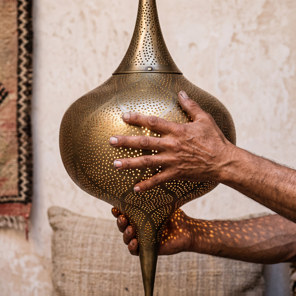Maker's hands holding the tall Zagora lantern, unlit