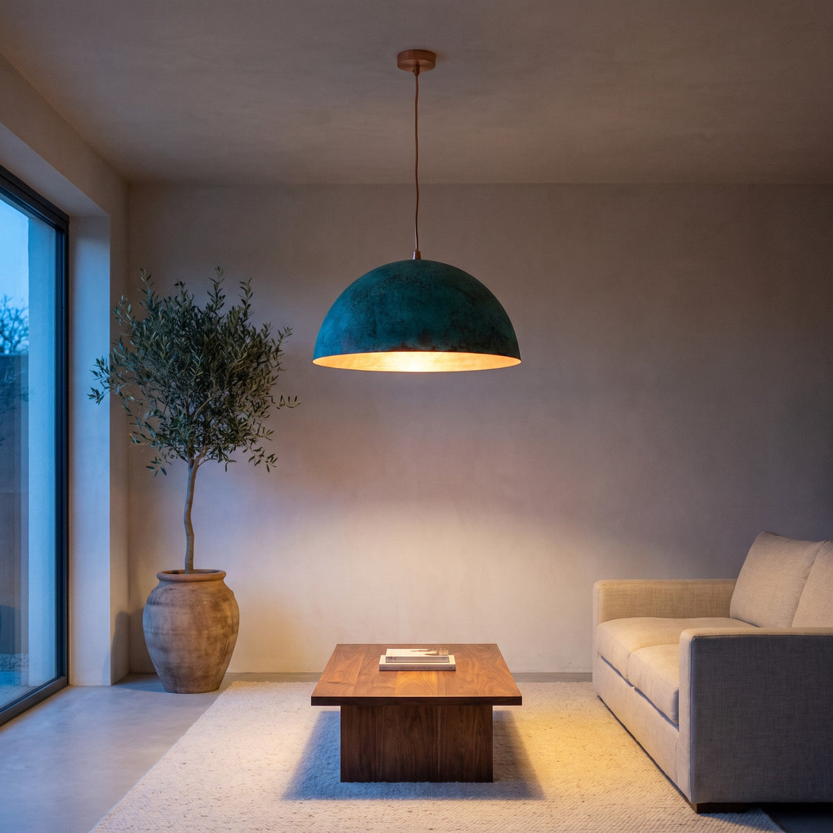 Zitoun green patina dome pendant above a kitchen island in a modern home